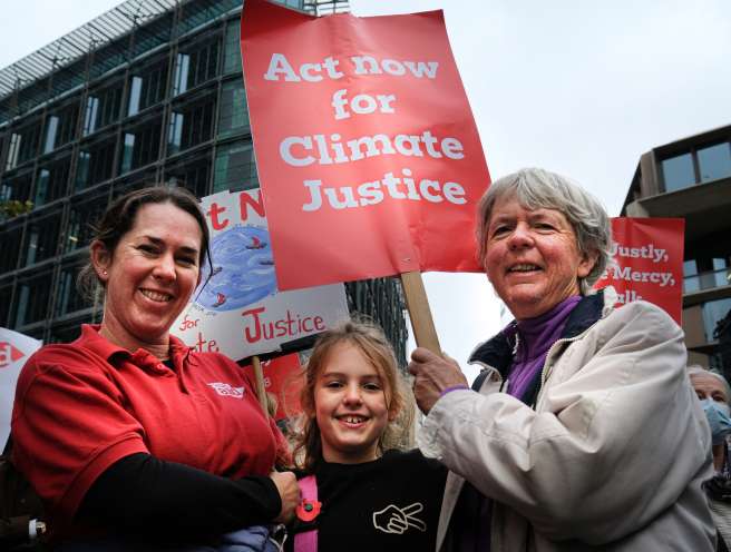 three people protesting for climate justice